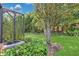 Landscaped backyard featuring an air conditioning unit and lush plants, offering a private and well-maintained outdoor area at 163 Shell Falls Dr, Apollo Beach, FL 33572