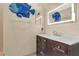Bathroom with vibrant blue fish decor and lighted mirror above the vanity at 163 Shell Falls Dr, Apollo Beach, FL 33572