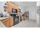Functional kitchen with tiled floors, countertops, black appliances, and ample cabinet storage at 163 Shell Falls Dr, Apollo Beach, FL 33572