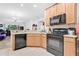 Well-lit kitchen featuring granite counters, black appliances and lots of storage at 163 Shell Falls Dr, Apollo Beach, FL 33572