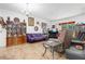 Open-concept living room featuring tile flooring, a chandelier and access to the screened lanai at 163 Shell Falls Dr, Apollo Beach, FL 33572