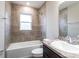 Full bathroom featuring a shower-tub combo, modern vanity, and neutral tiling at 6021 Mangrove Creek Rd, Wimauma, FL 33598