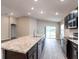 View of a kitchen featuring granite countertops, stainless steel appliances, and an open floor plan at 6021 Mangrove Creek Rd, Wimauma, FL 33598