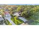 Aerial view of a property showing its expansive lot, pool, detached garage, and lush landscaping at 607 N Merrin St, Plant City, FL 33563