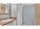 Bathroom featuring a vanity sink, large mirror, and ample storage for a clean and organized space at 607 N Merrin St, Plant City, FL 33563