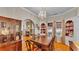 Charming dining room with hardwood floors, a decorative fireplace, and an elegant display cabinet at 607 N Merrin St, Plant City, FL 33563
