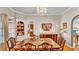 Formal dining room with classic furniture, a chandelier, and a built-in cabinet, perfect for hosting elegant dinners at 607 N Merrin St, Plant City, FL 33563