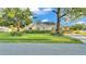 Charming home exterior with a well-manicured lawn and mature trees at 607 N Merrin St, Plant City, FL 33563