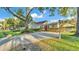Traditional home exterior featuring a well-kept lawn and mature trees at 607 N Merrin St, Plant City, FL 33563