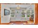 Warm and inviting foyer with terra cotta floors, a traditional front door, and windows at 607 N Merrin St, Plant City, FL 33563