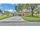 Charming home boasts lush landscaping, covered parking, and a welcoming fountain, blending comfort and curb appeal at 607 N Merrin St, Plant City, FL 33563