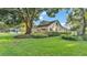 Landscaped front yard showcasing a well-maintained lawn and mature trees at 607 N Merrin St, Plant City, FL 33563