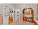 Hallway with a view to wood floors, light pink walls, and custom wood shelving at 607 N Merrin St, Plant City, FL 33563