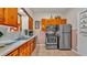 Cozy kitchen with stainless steel appliances, wood cabinets, and a classic tile backsplash at 607 N Merrin St, Plant City, FL 33563