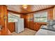 Practical laundry area with window lighting, wooden paneling, and modern appliances at 607 N Merrin St, Plant City, FL 33563