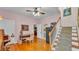Cozy living room with hardwood floors, a desk, and a staircase leading to the upper level of the home at 607 N Merrin St, Plant City, FL 33563