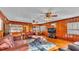 Inviting living room features wood paneling, ample natural light, and an entertainment area at 607 N Merrin St, Plant City, FL 33563