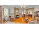Cozy living room with hardwood floors, a decorative fireplace, and elegant furnishings, creating a warm ambiance at 607 N Merrin St, Plant City, FL 33563