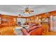 Spacious living room featuring wood paneling, ceiling fans, and comfortable leather seating at 607 N Merrin St, Plant City, FL 33563