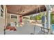 Covered patio with a swing, seating, and an area for outdoor dining by the pool at 607 N Merrin St, Plant City, FL 33563