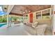 Covered patio with seating, swing, and ceiling fans perfect for outdoor relaxation at 607 N Merrin St, Plant City, FL 33563