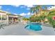 Backyard showcasing a sparkling swimming pool with a connected patio and outdoor entertainment space at 607 N Merrin St, Plant City, FL 33563