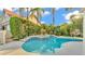 Inviting backyard pool with tiled spa and lush tropical landscaping provides a private oasis at 607 N Merrin St, Plant City, FL 33563