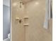 Tiled shower stall with built-in shelves and a handheld shower head for a convenient and clean bathroom at 607 N Merrin St, Plant City, FL 33563