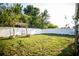 Green backyard with a white vinyl fence and a swing, perfect for outdoor activities at 11567 Misty Isle Ln, Riverview, FL 33579