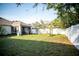 Expansive backyard with lush lawn, patio area, and privacy fence perfect for outdoor entertaining at 11567 Misty Isle Ln, Riverview, FL 33579