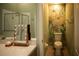 Bathroom featuring double sinks, a mirror, and floral accents at 11567 Misty Isle Ln, Riverview, FL 33579
