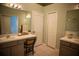 Spacious bathroom with dual vanities, chair, and storage, offering functionality and ample space at 11567 Misty Isle Ln, Riverview, FL 33579