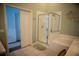 Bright bathroom features a shower and soaking tub combo and a decorative mirror wall hanging at 11567 Misty Isle Ln, Riverview, FL 33579