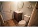Cozy bathroom with wood-look flooring, modern vanity and round mirror at 11567 Misty Isle Ln, Riverview, FL 33579