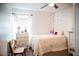 Cozy bedroom with white comforter, painted heart accents and decorative dresser at 11567 Misty Isle Ln, Riverview, FL 33579
