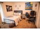 Well-lit bedroom with a bed, computer desk, and urban wall decor at 11567 Misty Isle Ln, Riverview, FL 33579