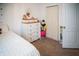 Well-lit bedroom featuring white dresser and closet near a comfy bed at 11567 Misty Isle Ln, Riverview, FL 33579
