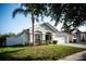 Single-story home featuring a two-car garage and a neatly manicured lawn at 11567 Misty Isle Ln, Riverview, FL 33579