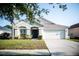 Charming single-story home with a well-maintained lawn and a two-car garage at 11567 Misty Isle Ln, Riverview, FL 33579