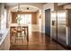View of open floorplan with kitchen, breakfast area, and stainless steel refrigerator at 11567 Misty Isle Ln, Riverview, FL 33579