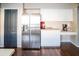 An additional view of the kitchen highlighting a stainless steel refrigerator and coffee station at 11567 Misty Isle Ln, Riverview, FL 33579