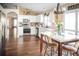 Bright kitchen with white cabinets, stainless steel appliances, and a center island dining table at 11567 Misty Isle Ln, Riverview, FL 33579