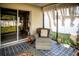 Relaxing lanai featuring patterned flooring, a comfortable chair, and sliding glass doors at 11567 Misty Isle Ln, Riverview, FL 33579