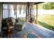Inviting lanai with neutral furniture, curtains, and plants, perfect for relaxation at 11567 Misty Isle Ln, Riverview, FL 33579