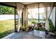 Cozy lanai with sheer curtains and various potted plants, creating a serene outdoor space at 11567 Misty Isle Ln, Riverview, FL 33579