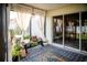 Bright lanai with sheer curtains, plants and outdoor seating providing a peaceful retreat at 11567 Misty Isle Ln, Riverview, FL 33579