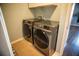 Modern laundry room featuring front-load Samsung washer and dryer units at 11567 Misty Isle Ln, Riverview, FL 33579