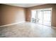 Open living room featuring sliding glass doors to screened patio at 11567 Misty Isle Ln, Riverview, FL 33579