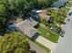 Aerial view of the home, showing a well-maintained lawn and roof against a treed backdrop at 13411 Whitby Rd, Hudson, FL 34667