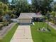 Aerial view of a single-story home with a well-kept lawn and driveway with street access at 13411 Whitby Rd, Hudson, FL 34667